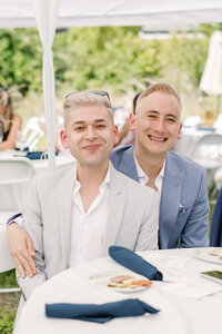 bay area photographers captures lgbt wedding with husbands posing together at their outdoor wedding reception