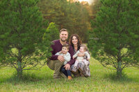 Family at Christmas tree farm enjoying their Raleigh maternity photography by Susan VanNess Photography