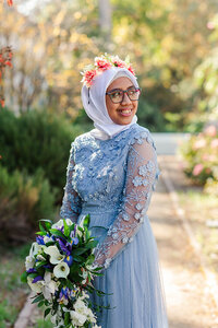 Bride smiling in wedding portrait at Scripps college rose garden
