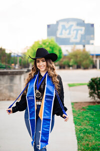 Senior wearing cowgirl hat and blue MTSU stole