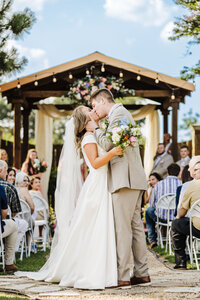 bride and groom kissing at The Carriage Place Wedding and Event center in Marshall, TX