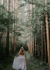 a-woman-walking-through-a-forest_t20_4ed408