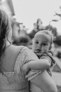 Outdoor family photoshoot in Omaha park during golden hour – capturing candid, heartfelt moments.
