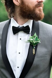 groom wearing a all greenery boutonniere