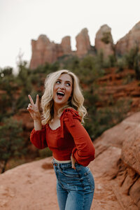 woman holding up peace sign