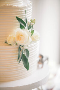wedding cake with white roses and greenery at the trillium venue in sevierville tennessee