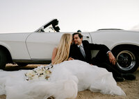 couple sitting in front of car