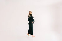 Springfield MO maternity photographer captures pregnant couple cuddling in studio