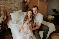 Owner of a WI wedding planning company, Liz, event planner milwaukee, with her husband and daughter in a family photo.