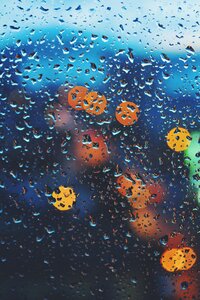 Blurry bokeh image of lights through a rainy window