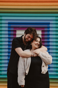 A person hugging their partner from behind 
