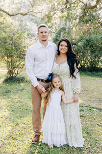 Family of 4 smiling at camera