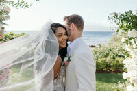Maui Elopement Photographer captures couple playing in water after small beach wedding