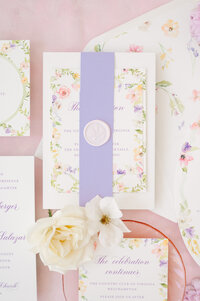 Fun, whimsical wedding invitation with purple belly band and wax seal