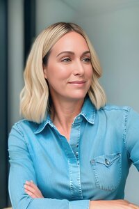 WOMAN JO WOOD IN DENIM SHIRT SMILING AND SIDE PROFILE