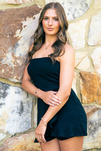 a senior girl poses during her senior photoshoot