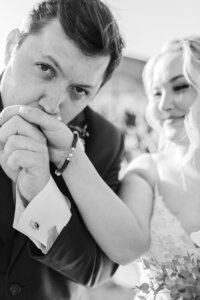 groom kisses brides hand