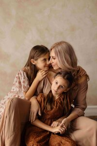 in a studio shoot with a mother with her 2 daughter and very intimate shoot