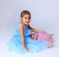 Beth Benecki of E. Benecki Photography,  photographed this low key studio lighting image for family newborn photo session