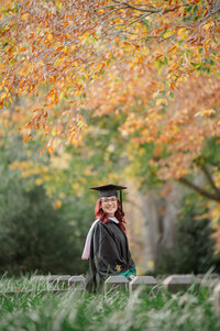 college graduate in white dress holding graduation cap at William and Mary