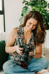 Jaime Bugbee, professional family film maker + videographer in Portland, posing with her camera