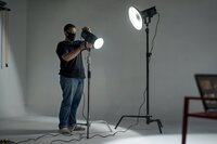 Behind-the-scenes of studio lighting setup for brand video production and photography session and preparing professional studio setup for high-end video production