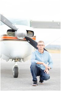 Senior guy smiles with arms crossed for Hamilton Montana senior pictures