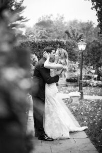 bride and groom kissing in a garden
