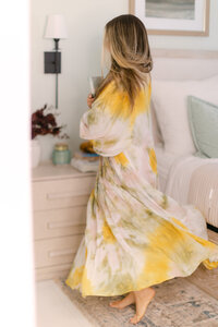 Merlyn Asencio spinning joyfully in her room, reflecting a playful and free-spirited approach to healing and personal growth in her trauma therapy practice in Miami, Florida