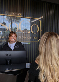 A client being welcomed into SoCo Head Spa’s calming atmosphere.