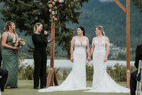 Wedding officiant smiling with newlyweds