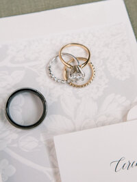 set of rings on lace fabric and invitations