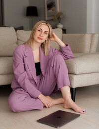 a girl sitting on the floor with laptop