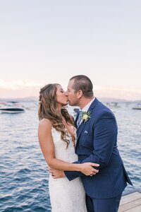 couple kissing in front of water
