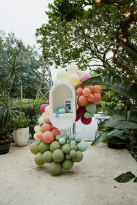 Wedding guests dance underneath ambient market lighting