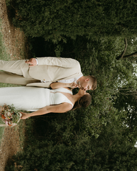 couple sitting together in a grassy Kansas field during their intimate wedding celebration

