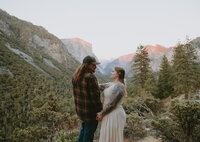 Woman smiling at man in front of tunnel view in yosemite