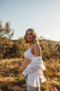 Family holding baby with bushland background