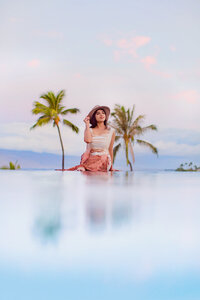 drone portrait of bride in large fluffy gown photographed on a maui beach at sunrise