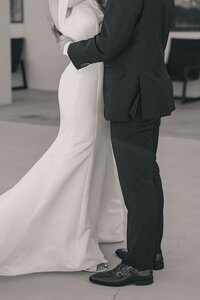 bride and groom embrace at wedding reception in oklahoma