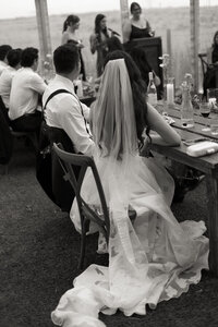 couple sitting together at reception listening to speeches
