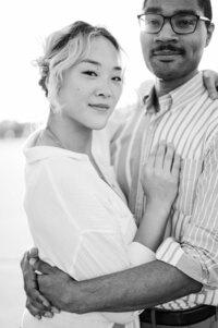 Engaged couple embrace during their engagement session at The Crescent Hill Reservoir