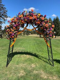 Large, colorful floral arch design by Springfield Oregon florist Flowers and Thyme.