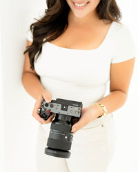 branding photo for luxury wedding videographer holding a camera