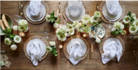 Elegant overhead view of a beautifully arranged table with white linens, floral decor, and glassware, styled by Ylva Erevall.