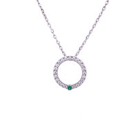 circle pendant set with white diamonds and single emerald in white gold