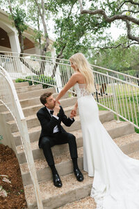 couple sits at the bottom of blacks beach in san diego california after renewing their vows.