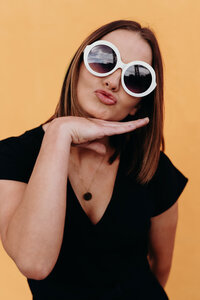 Fitness Coach Brenda Lott, Coach for the LIVE BIG Collective posing confidently with sunglasses on 
