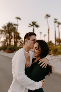 man kissing womans forehead