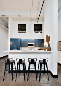 Bar seating at kitchen island in this 2-bedroom, 2-bathroom luxury condo in the historic Behrens building in downtown Waco, TX